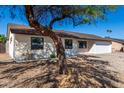 Newly renovated single story home with a landscaped front yard and attached garage at 15840 N 22Nd St, Phoenix, AZ 85022