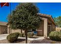 Tan house with two-car garage and landscaped yard at 22608 W Gardenia Dr, Buckeye, AZ 85326
