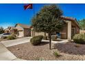 Tan houses with two-car garages and landscaped yards at 22608 W Gardenia Dr, Buckeye, AZ 85326