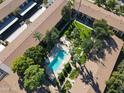 Aerial view showcasing a community pool surrounded by lush landscaping and apartment buildings at 4701 N 68Th St # 144, Scottsdale, AZ 85251