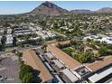 Aerial view of an apartment complex with a pool and landscaped grounds, near Camelback Mountain at 4701 N 68Th St # 144, Scottsdale, AZ 85251