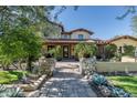 Stunning two-story home with stone accents and a tile roof, showcasing a beautiful landscape at 20242 N 103Rd Way # 1246, Scottsdale, AZ 85255
