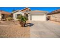 Charming single story home with a two car garage and desert landscaping at 980 S 220Th Ln, Buckeye, AZ 85326