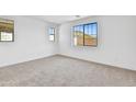 Bright bedroom with neutral carpeting and large window at 31327 N 130Th Ave, Peoria, AZ 85383