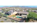 Aerial view showcasing the home, pool, and surrounding neighborhood at 16918 S 180Th Dr, Goodyear, AZ 85338