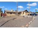 Single-story home with a two-car garage and gravel landscaping at 15402 N 56Th Ave, Glendale, AZ 85306