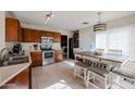 Kitchen with stainless steel appliances and a wooden table at 1098 E Nardini St, San Tan Valley, AZ 85140