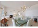 Bright living room with fireplace, dining area, and chandelier at 20407 N Tanglewood Dr, Sun City West, AZ 85375