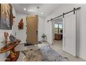 Bright and spacious entryway with barn doors leading to an office at 2995 W Pinto Pl, Wickenburg, AZ 85390