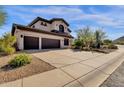 Two-story house with desert landscaping and a three-car garage at 15439 E Acacia Way, Fountain Hills, AZ 85268