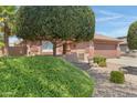 Neat front yard with lush shrubs and gravel at 16453 W Central St, Surprise, AZ 85388