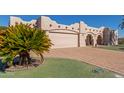 Single story home with stucco exterior, double garage and manicured lawn at 9518 W Hidden Valley Cir, Sun City, AZ 85351