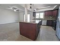 Kitchen with granite island and dark wood cabinetry at 8214 E Mcdonald Dr, Scottsdale, AZ 85250