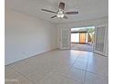 Living room with tile flooring and access to backyard at 8214 E Mcdonald Dr, Scottsdale, AZ 85250