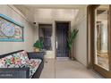 Front entry featuring a dark wood door and a sitting area at 7297 N Scottsdale Rd # 1004, Paradise Valley, AZ 85253