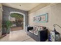 Inviting front porch with seating area and decorative wall art at 7297 N Scottsdale Rd # 1004, Paradise Valley, AZ 85253