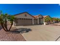 Single-story home with tan exterior and palm trees at 2222 S Yellow Wood --, Mesa, AZ 85209