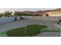 Landscaped backyard with putting green and mountain views at 4126 S Last Chance Trl, Gold Canyon, AZ 85118