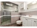 Bathroom with walk-in shower and tiled walls at 19222 N 133Rd Ave, Sun City West, AZ 85375