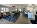 Bright living room with large mirror reflecting space at 14416 N Teakwood Ln # D, Fountain Hills, AZ 85268