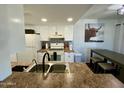Modern kitchen with white cabinets and granite counters at 14416 N Teakwood Ln # D, Fountain Hills, AZ 85268