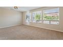 Spacious bedroom with large windows and neutral carpeting at 15936 W Kino Dr, Surprise, AZ 85374