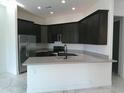 Modern kitchen with dark cabinetry and quartz countertops at 846 N Pueblo Dr # 138, Casa Grande, AZ 85122