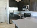 Modern kitchen with stainless steel appliances and an island at 846 N Pueblo Dr # 140, Casa Grande, AZ 85122