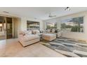 Bright Gathering room with sectional sofa and large windows at 19562 N Wikieup Ct, Surprise, AZ 85374