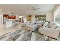 Open living room and kitchen with island and seating at 19562 N Wikieup Ct, Surprise, AZ 85374