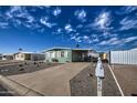 Mobile home exterior with gravel landscaping and a carport at 260 S 72Nd Pl, Mesa, AZ 85208