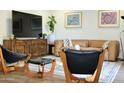 Living room with mid-century modern furniture and large TV at 103 E Palm Ln # A, Phoenix, AZ 85004