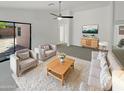 Spacious living room with light beige furniture and a large sliding glass door at 4657 W Carson Rd, Laveen, AZ 85339
