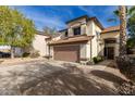 Two-story house with a brown garage door and landscaped yard at 20837 N 1St Dr, Phoenix, AZ 85027