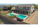 Backyard oasis with pool, putting green, and basketball hoop at 19428 W Colter St, Litchfield Park, AZ 85340