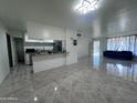 Open living area with tile floors and a view into the kitchen at 4232 W Citrus Way, Phoenix, AZ 85019