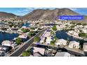 Aerial view of property located on a canal, with mountain views in the background at 20391 N 53Rd Ave, Glendale, AZ 85308