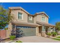 Two-story house with green garage doors and landscaping at 15298 W Linden St, Goodyear, AZ 85338