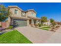 Two-story house with green garage doors and landscaping at 15298 W Linden St, Goodyear, AZ 85338