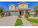 Two-story house with green garage doors and landscaping at 15298 W Linden St, Goodyear, AZ 85338