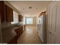 Eat-in kitchen with wood cabinets and tile flooring at 3030 S 102Nd Ln, Tolleson, AZ 85353