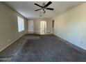 Bright living room featuring high ceilings and ceiling fan at 3030 S 102Nd Ln, Tolleson, AZ 85353