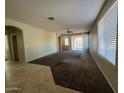 Spacious living room with neutral carpeting and large windows at 3030 S 102Nd Ln, Tolleson, AZ 85353