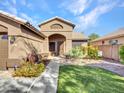 Single-story house with a two-car garage and a nicely landscaped yard at 916 E Beautiful Ln, Phoenix, AZ 85042