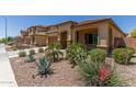 Tan house with brown garage door and desert landscaping at 5526 S Grenoble St, Mesa, AZ 85212