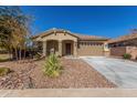 Tan two-car garage home with desert landscaping at 43958 W Stonecreek Rd, Maricopa, AZ 85139