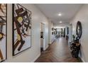 Bright hallway with herringbone tile floors, leading to the living areas at 26966 N 168Th Ln, Surprise, AZ 85387