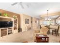 Open living and dining area with entertainment center and view to kitchen at 15813 W Arrowhead Dr, Surprise, AZ 85374