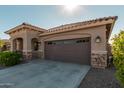 Home's exterior showcases a two-car garage and attractive landscaping at 20403 W Calle Encorvada --, Buckeye, AZ 85396