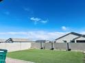 Artificial turf backyard with a privacy wall and ample space at 18195 N San Juan St, Maricopa, AZ 85138